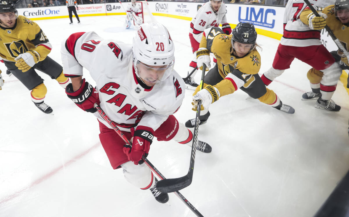 Carolina Hurricanes center Sebastian Aho (20) and Golden Knights center William Karlsson (71) f ...