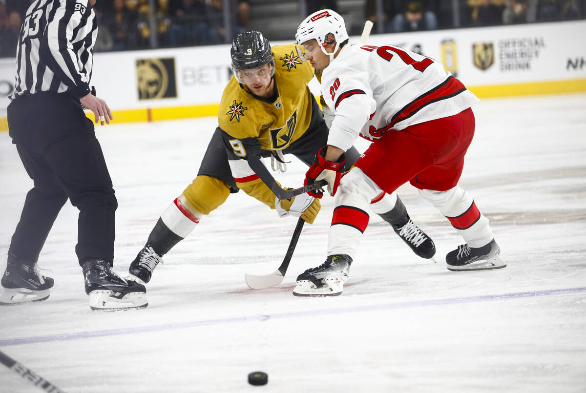 Golden Knights center Jack Eichel (9) passes the puck under pressure from Carolina Hurricanes c ...