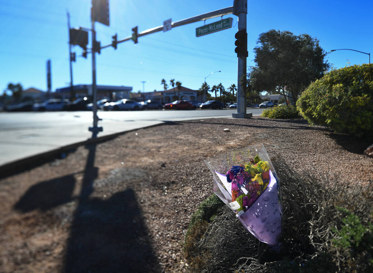 Flowers are placed at the scene of a fatal car accident at the intersection of Flamingo and Pec ...