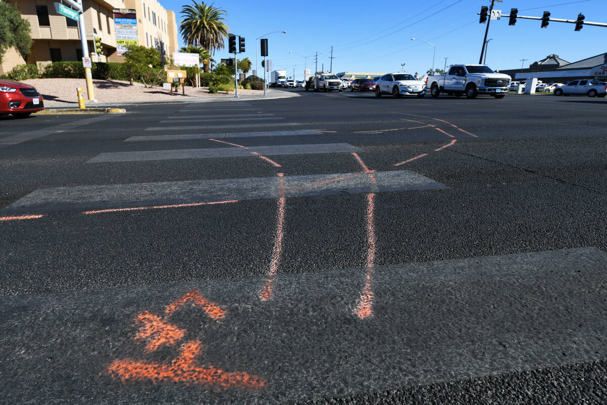 Markings are seen on the pavement at the scene of a fatal car accident at the intersection of F ...