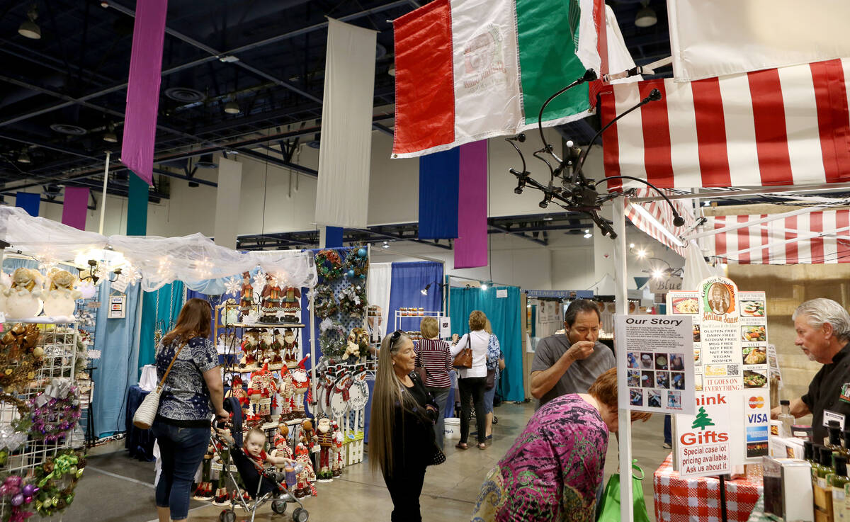 Individuals look around unique booths during the final day of the 2017 Craft Festival at the Ca ...