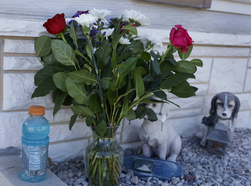 A lone bouquet of flowers in front of the house where Monique Gilbertson's body was found is se ...