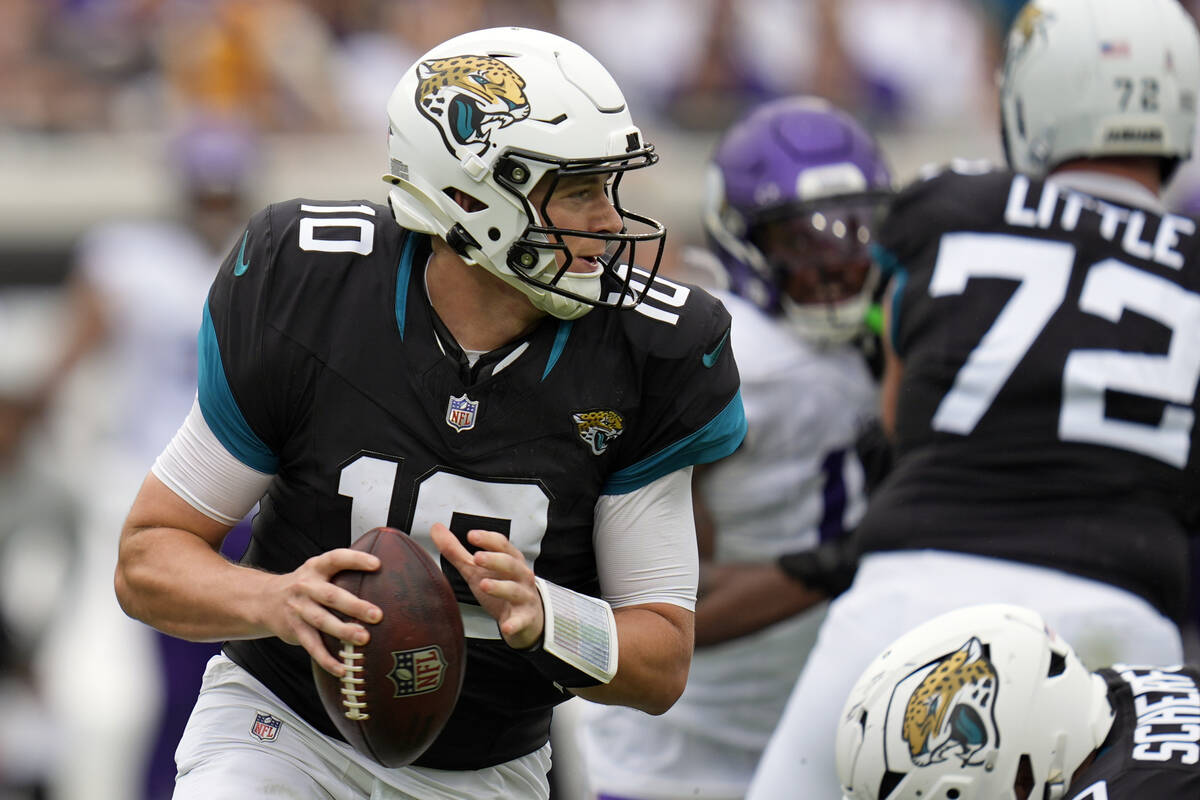 Jacksonville Jaguars quarterback Mac Jones scrambles against the Minnesota Vikings during the f ...