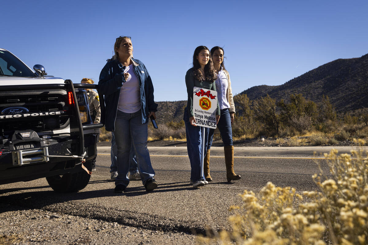 Angela Fernandez, center, walks alongside her mom, Maria Fernandez, right, and family friend Ch ...