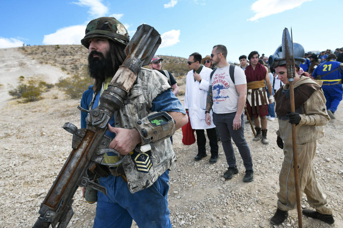 Brendan Kro from Sacramento carries a homemade rocket launcher while waiting to enter the Fallo ...