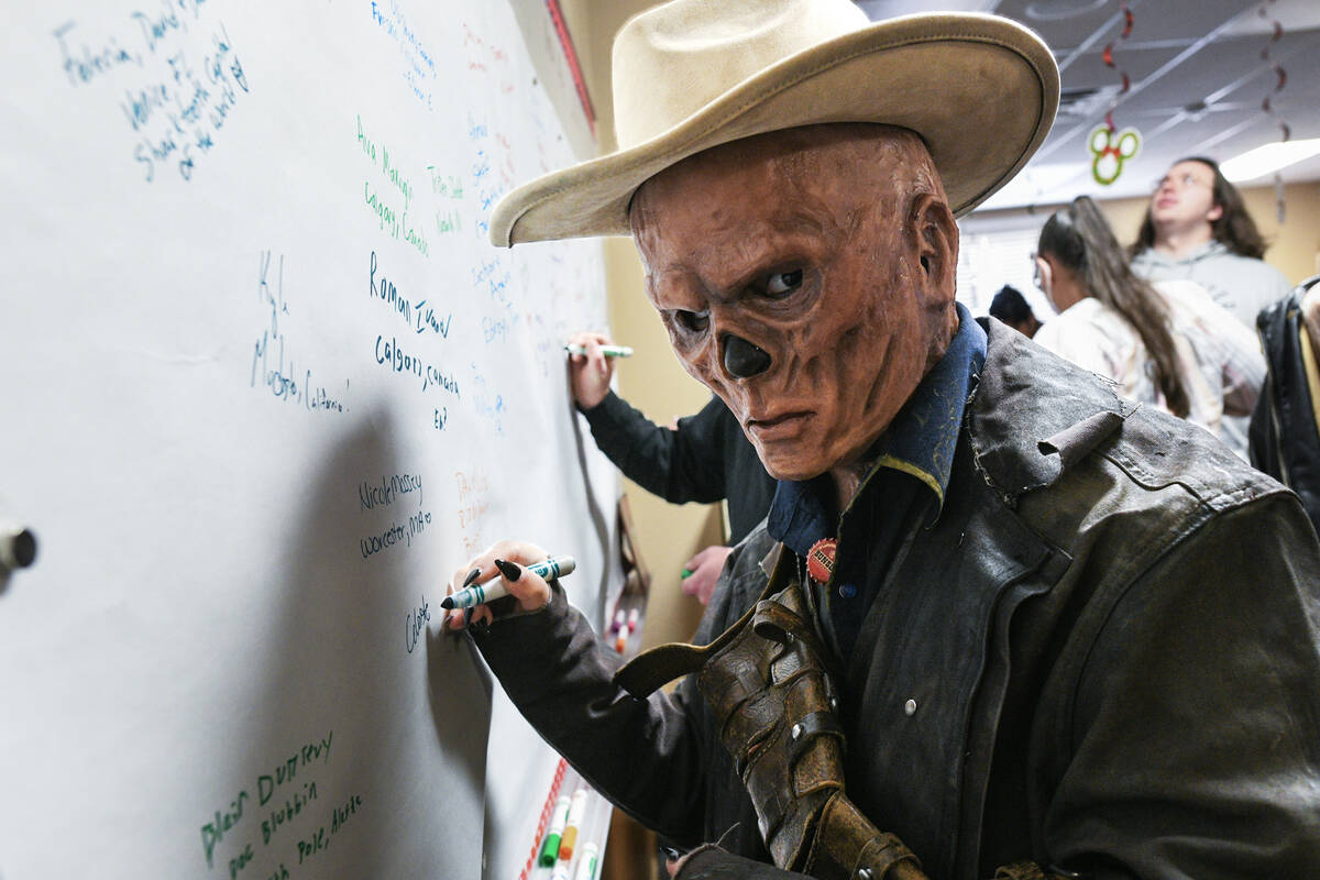 Celeste Freeman from Waco, Texas, signs her name on a board in the Goodsprings Elementary Schoo ...