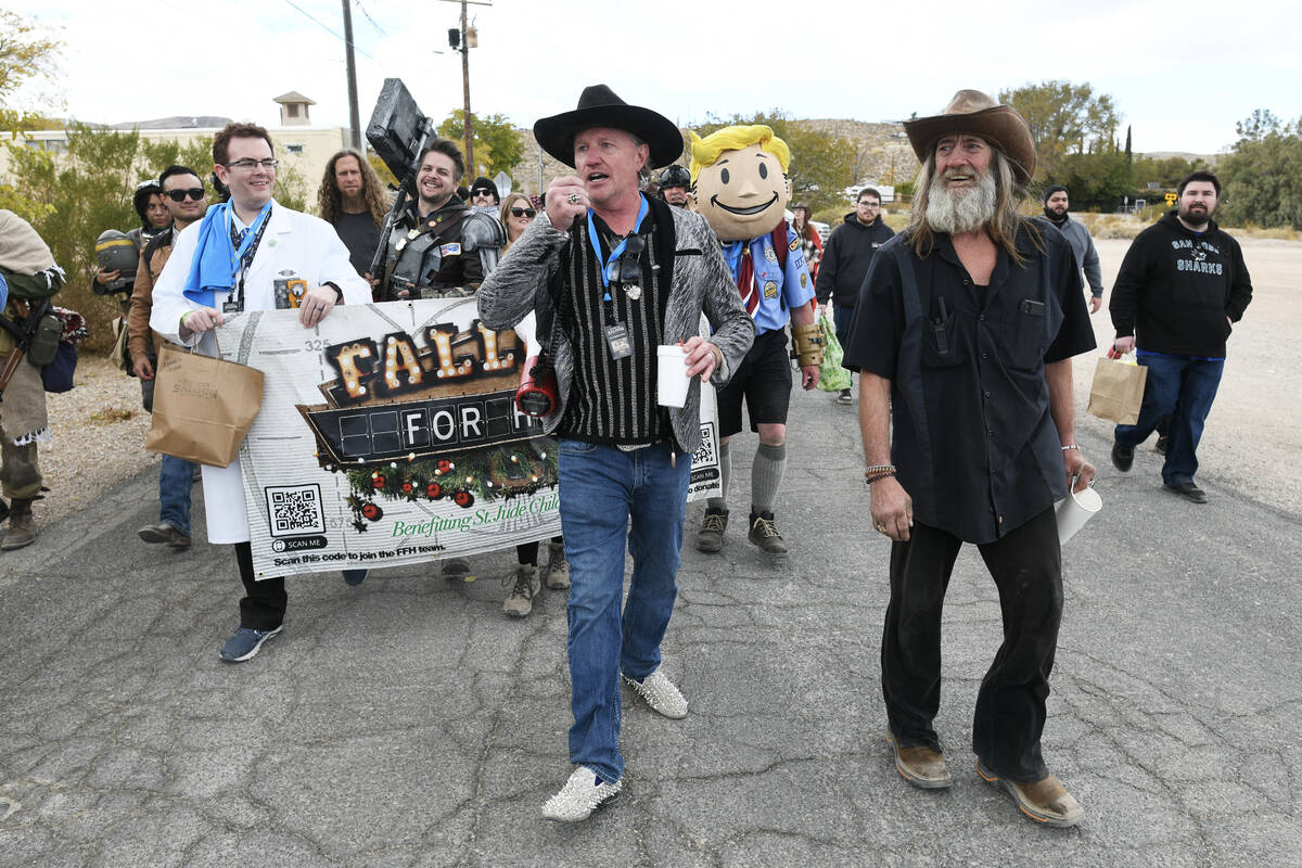 Pioneer Saloon owner Stephen "Old Man Liver" Staats, center, leads a walking tour dur ...