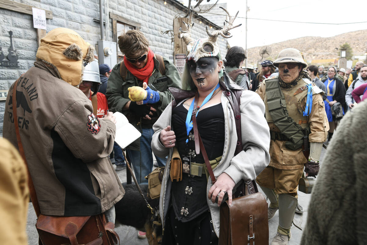 Attendees in costume make their way to the back of the Pioneer Saloon during the Fallout Fan Ce ...