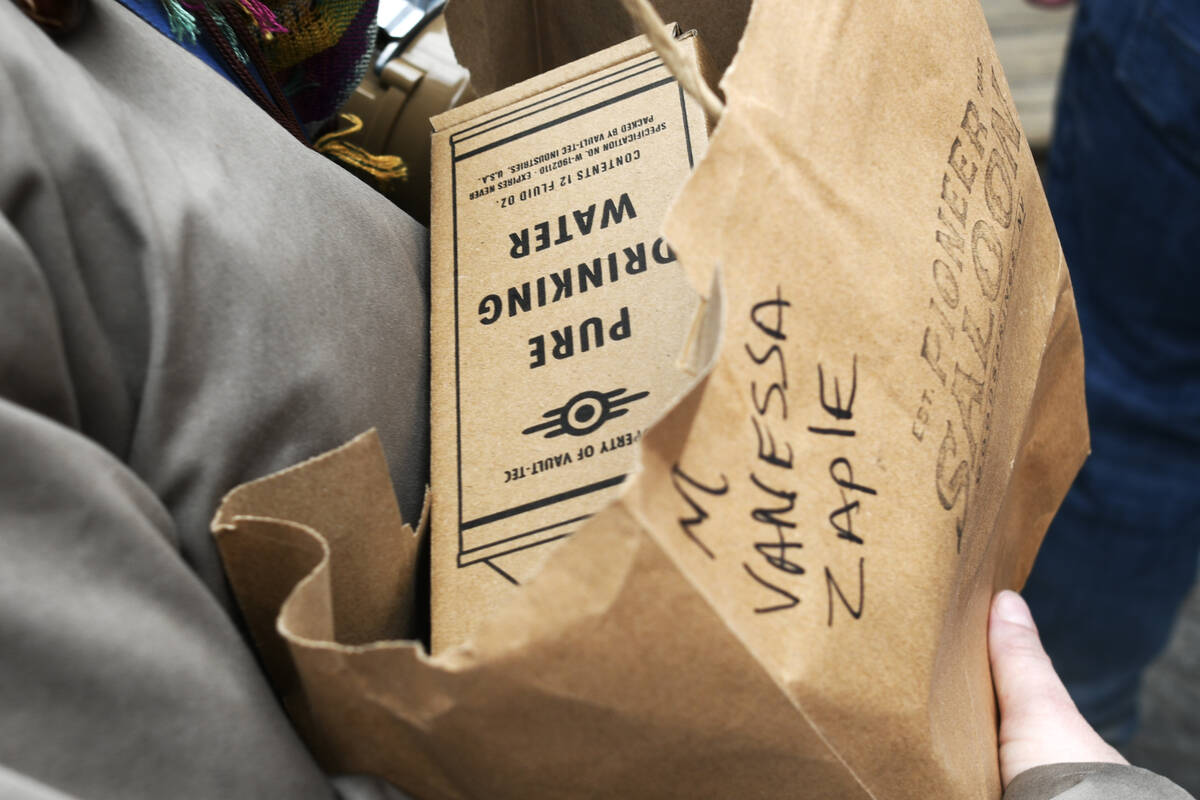 An attendee carries a bag of souvenirs during the Fallout Fan Celebration Saturday, November 16 ...