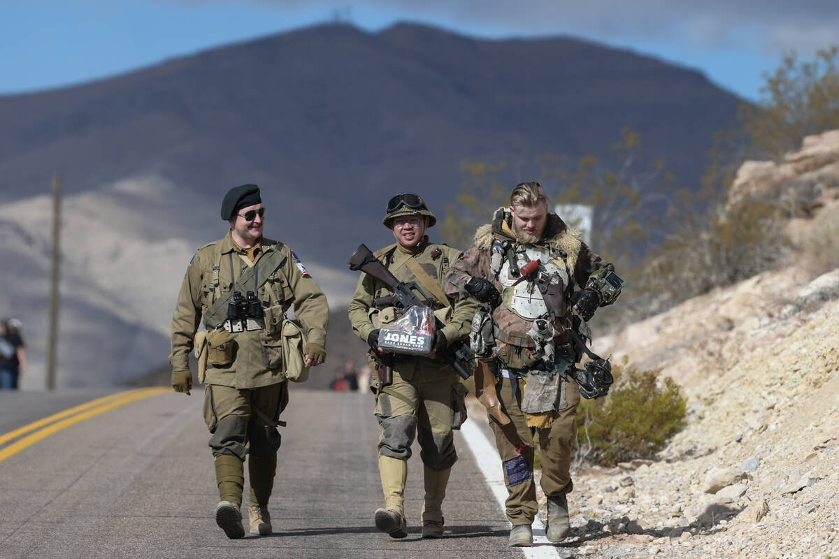 Attendees in costume walk down the road during the Fallout Fan Celebration Saturday, November 1 ...