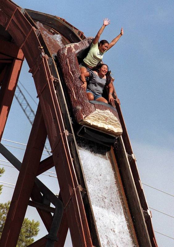 Two teens scream as they sail down a watery drop-off on the Over The Edge ride at the MGM Grand ...