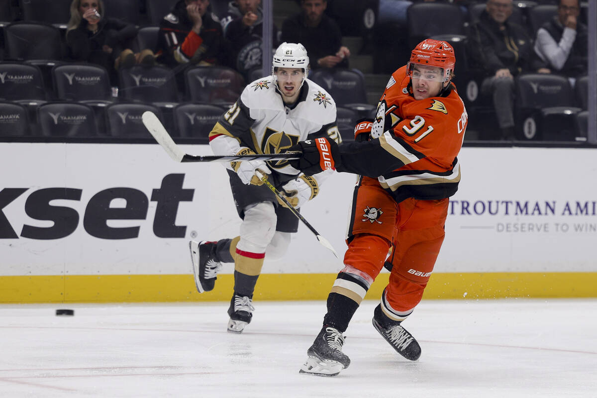 Anaheim Ducks center Leo Carlsson, right, shoots against Vegas Golden Knights center Brett Howd ...