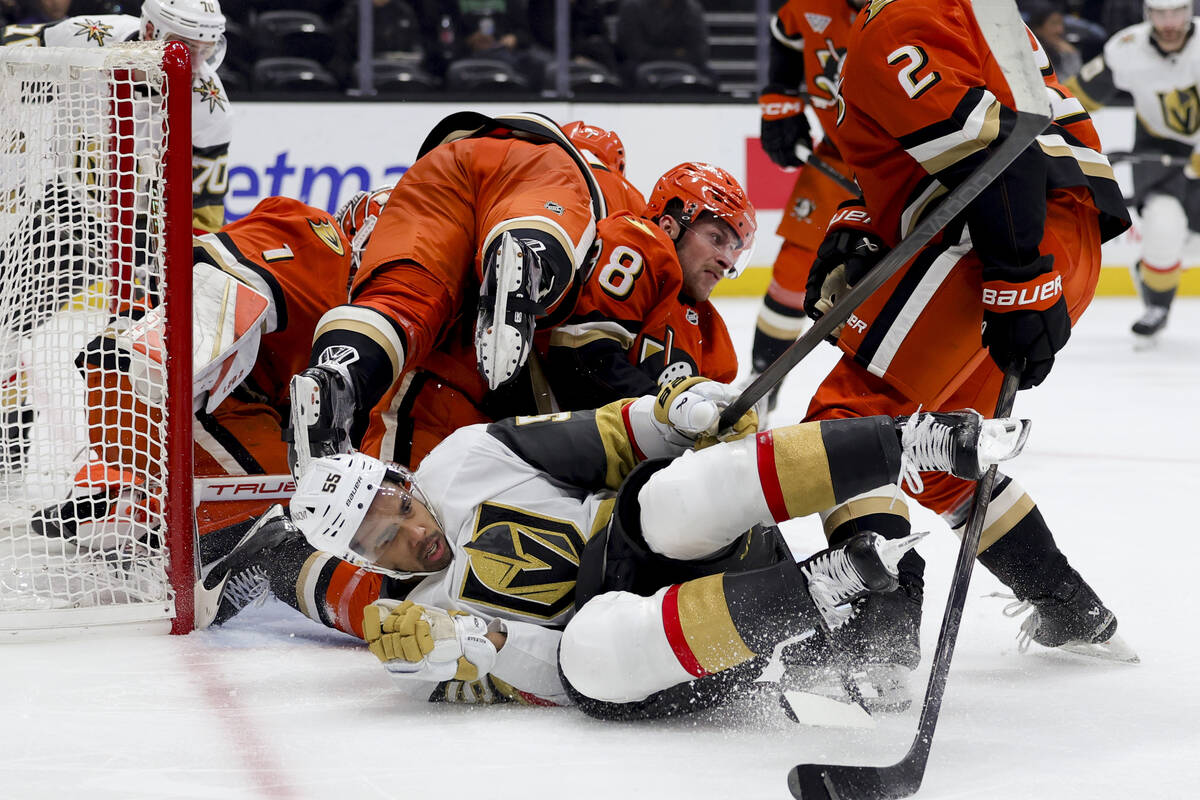 Vegas Golden Knights right wing Keegan Kolesar, bottom, collides with Anaheim Ducks defenseman ...