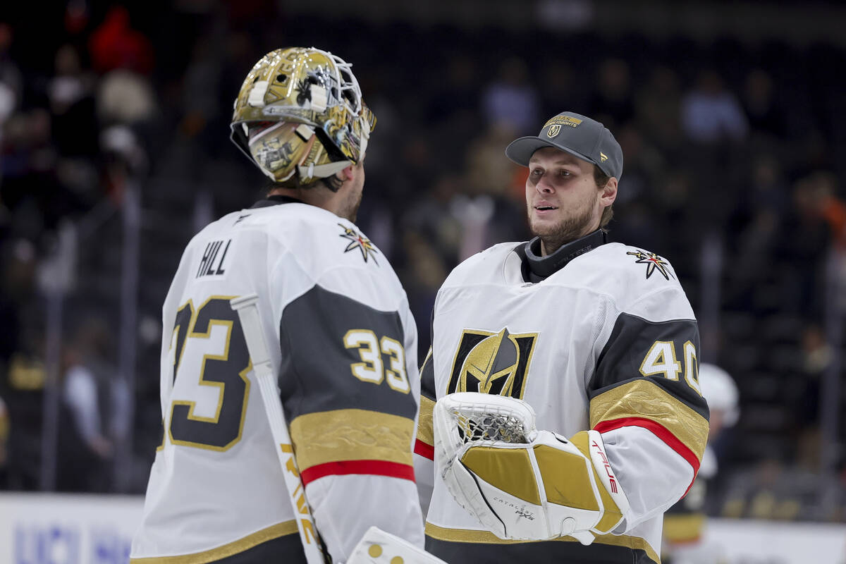 Vegas Golden Knights goaltender Adin Hill, left, greets goaltender Akira Schmid after the team' ...