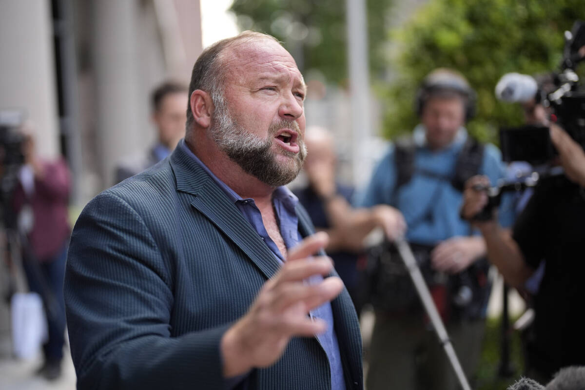 Right-wing conspiracy theorist Alex Jones speaks to the media after arriving at the federal cou ...