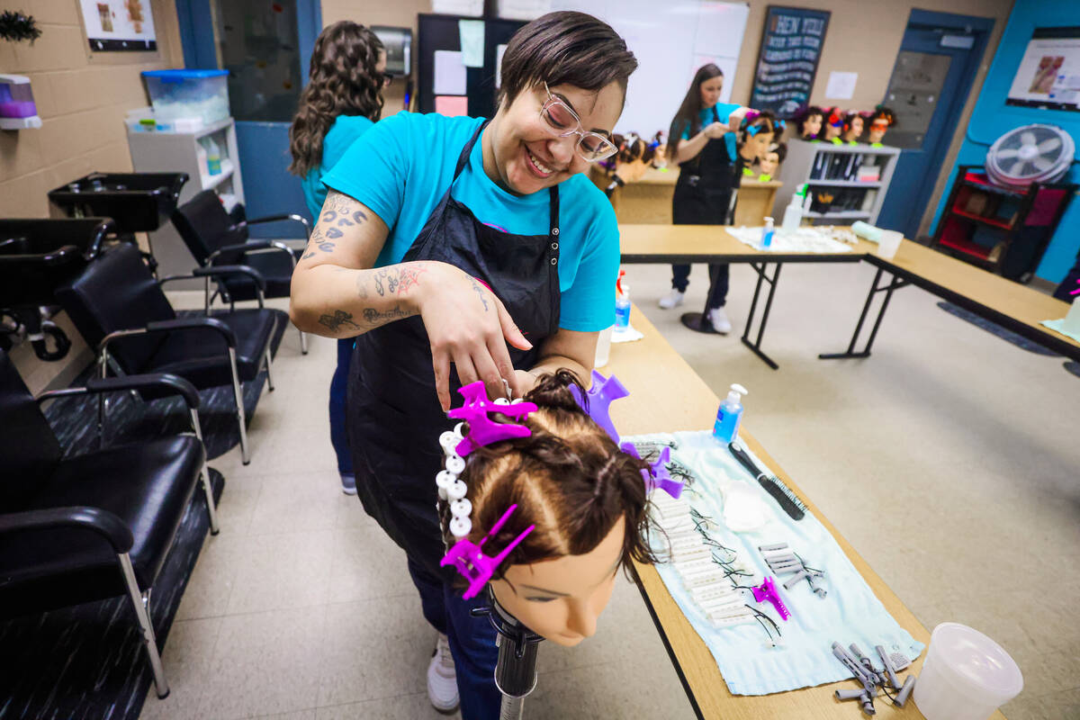 Lishae Macfield practices a perm during a cosmetology class at Florence McClure Women’s ...