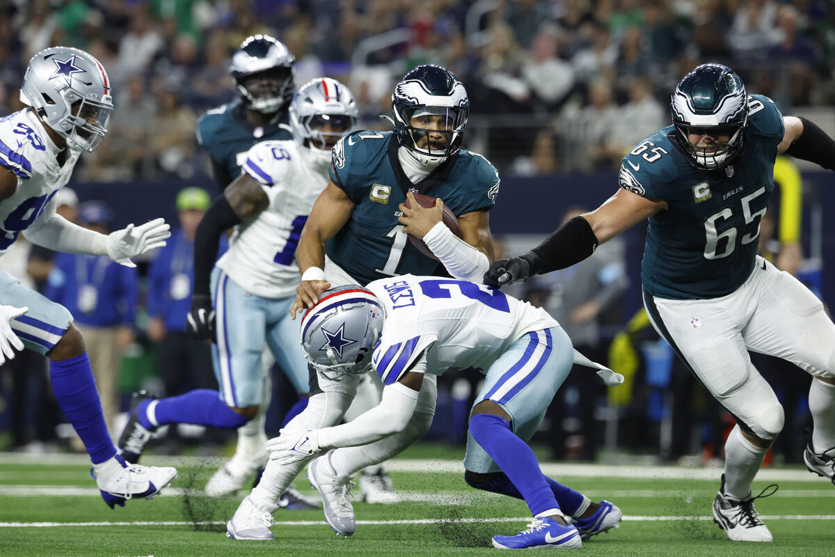 Philadelphia Eagles quarterback Jalen Hurts (1) carries the ball during an NFL football game ag ...