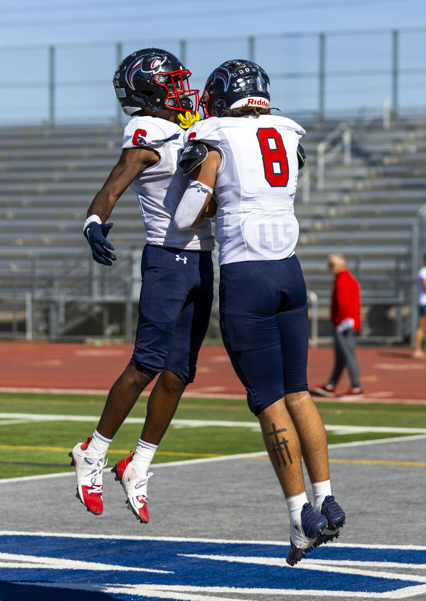 Coronado tight end Neville Roberts (8) celebrates a touchdown with running back Ty Tinner (3) a ...