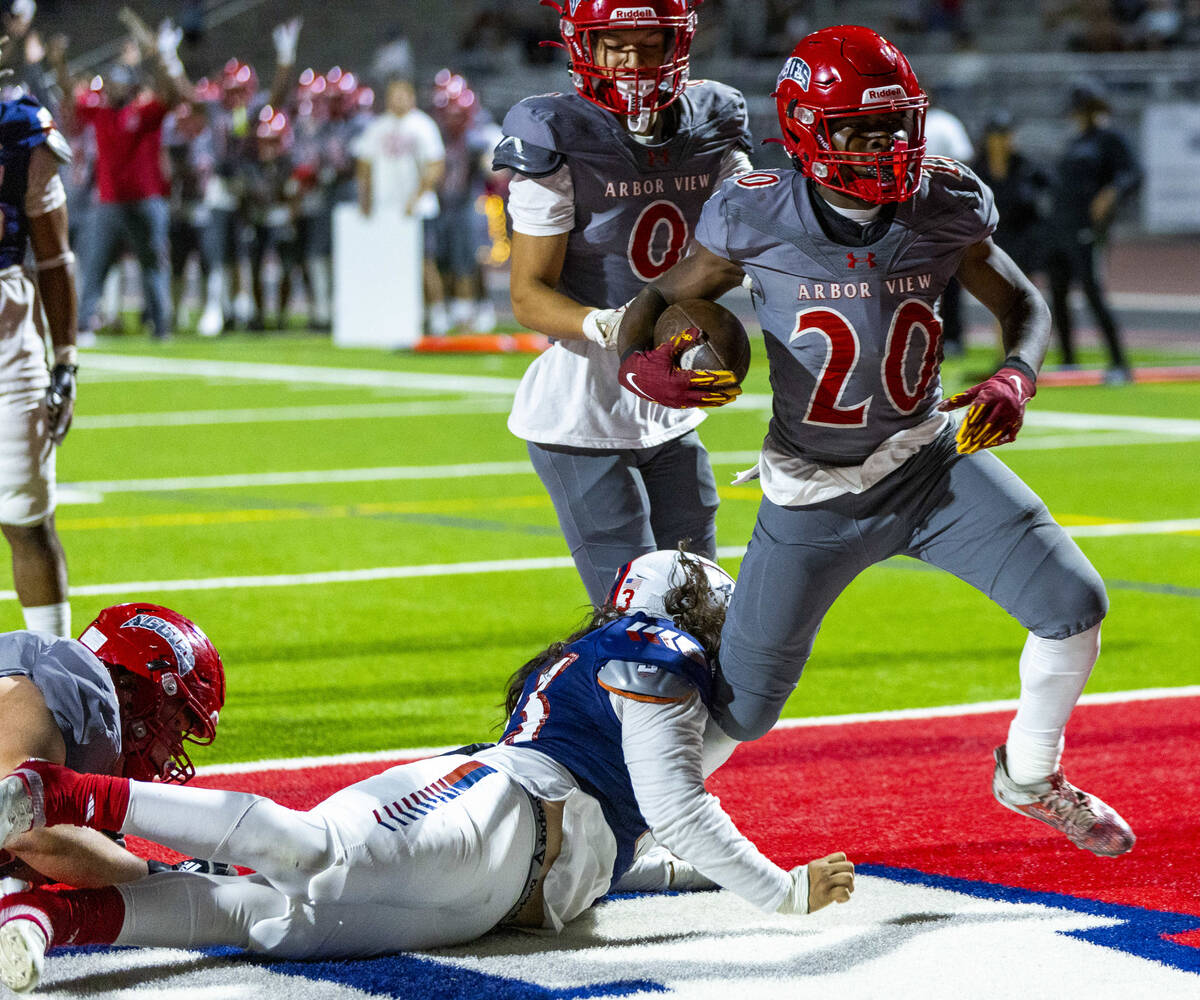 Arbor View running back Kamareion Bell (20) fights into the end zone against Liberty during the ...