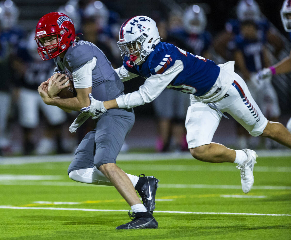 Arbor View quarterback Thaddeus Thatcher (7) is caught by Liberty defensive back Rysen Dacosin- ...