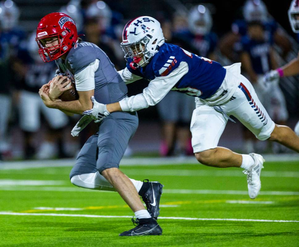 Arbor View quarterback Thaddeus Thatcher (7) is caught by Liberty defensive back Rysen Dacosin- ...