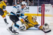 Golden Knights goaltender Adin Hill (33) looks to stop a shot by Utah Hockey Club forward Ryan ...