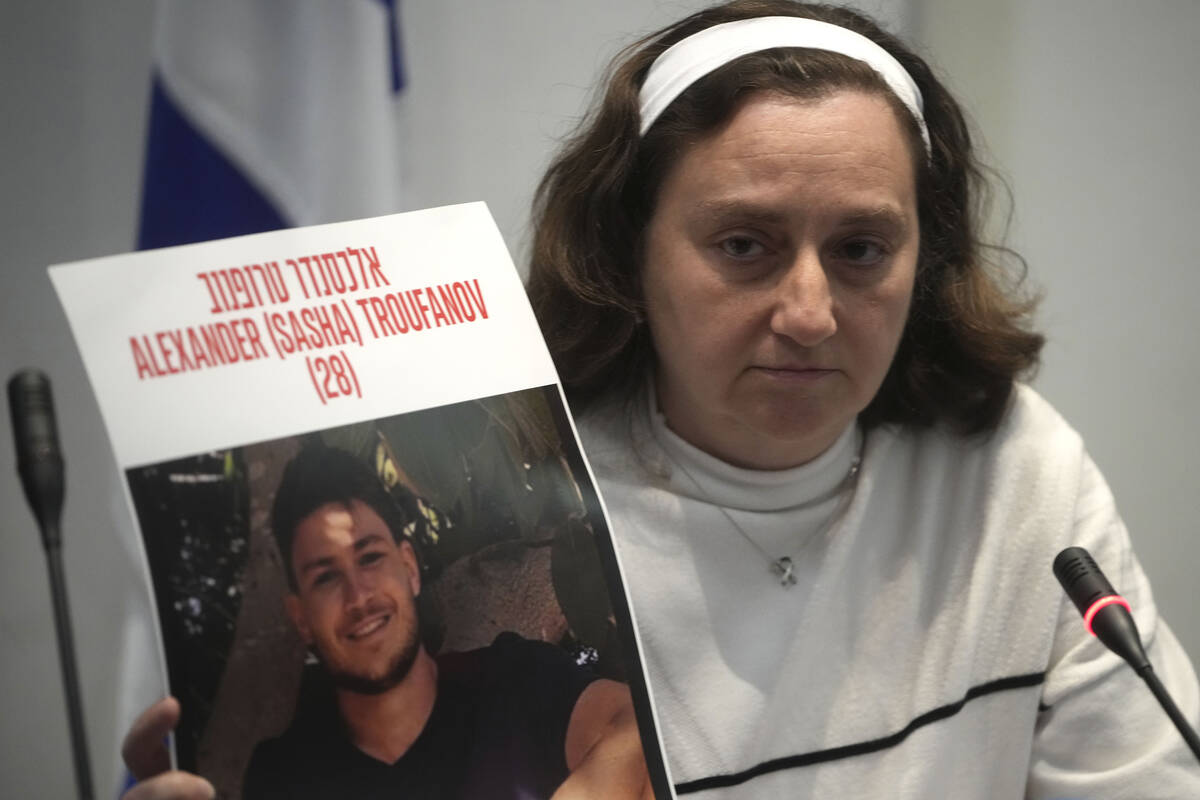 Former Israeli hostage Elena Troufanov holds a photo of his son, still held by Hamas, during a ...