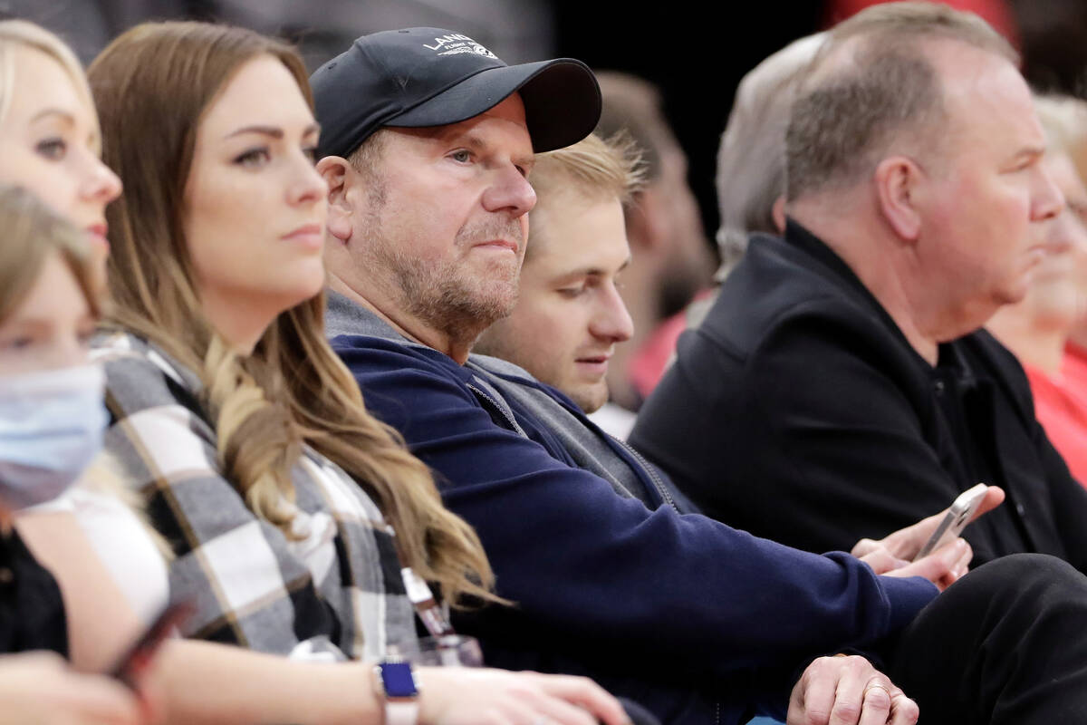 Houston Rockets owner Tillman Fertitta, center in hat, watches the game during the second half ...