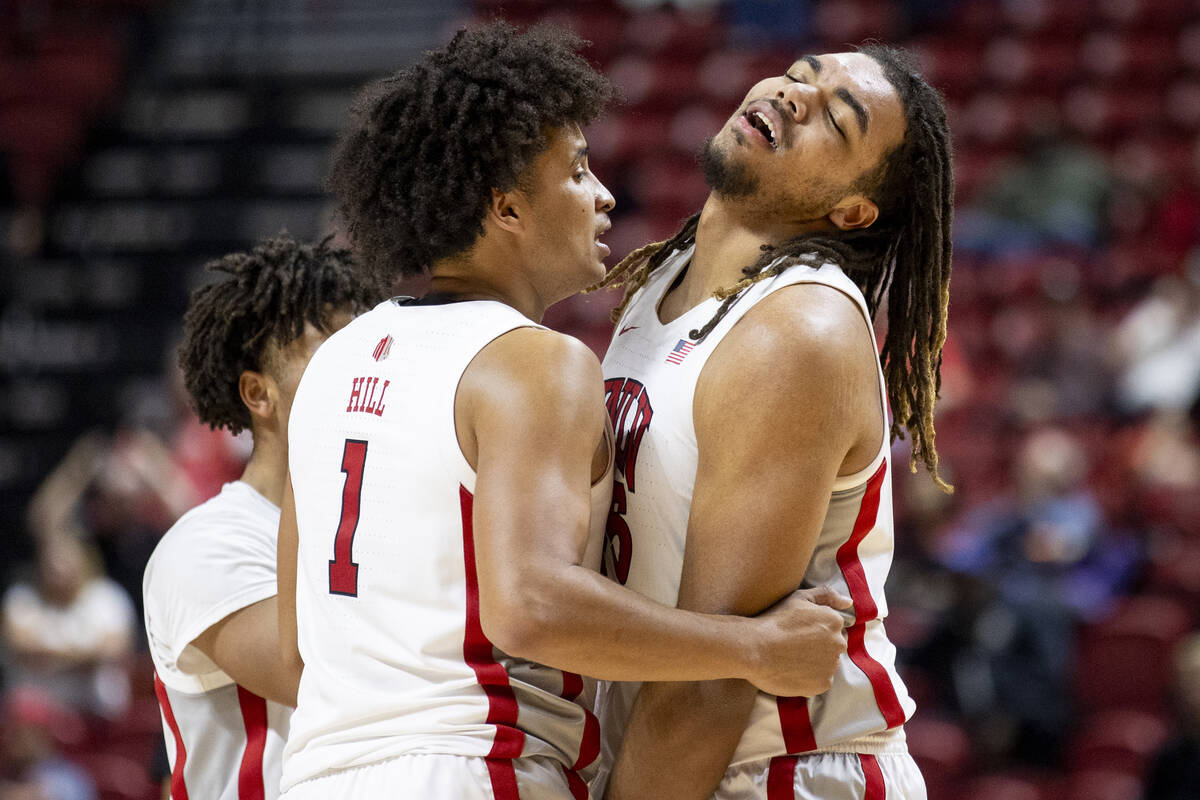 UNLV forward Jalen Hill (1) comforts forward Jeremiah Cherry, right, as Cherry receives his six ...