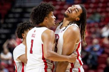 UNLV forward Jalen Hill (1) comforts forward Jeremiah Cherry, right, as Cherry receives his six ...