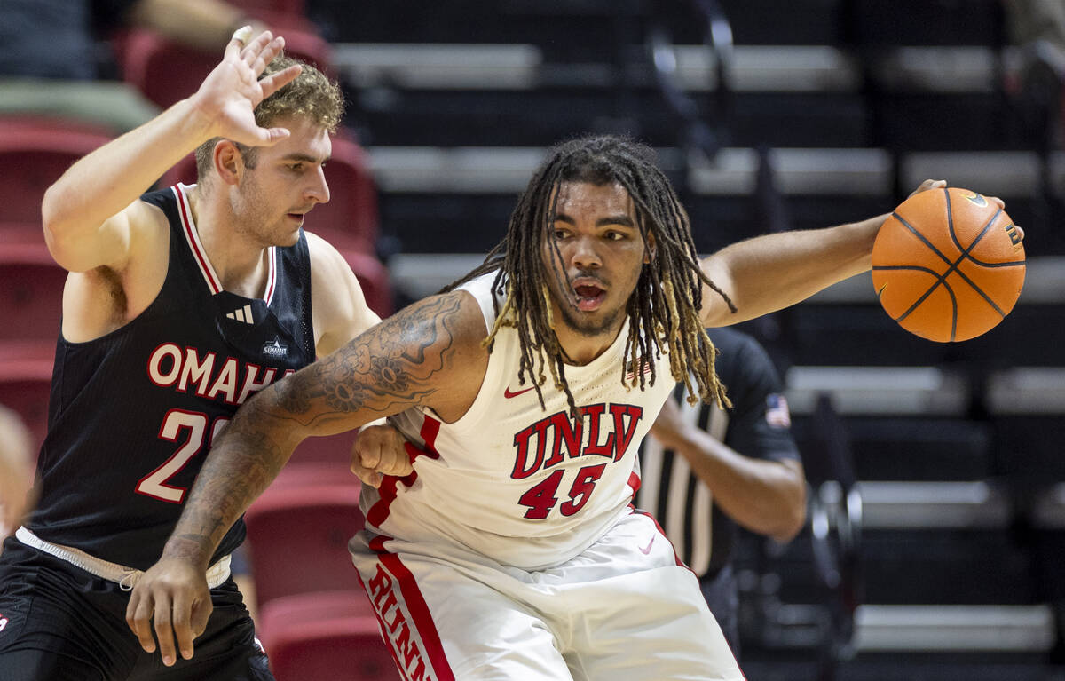 Omaha Mavericks forward Joshua Streit, left, and UNLV forward Jeremiah Cherry (45) compete duri ...