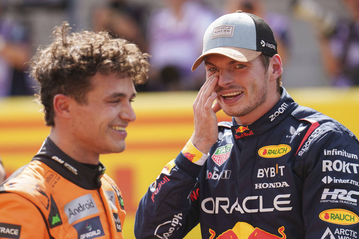 FILE - McLaren driver Lando Norris, of Britain, left, talks with Red Bull driver Max Verstappen ...