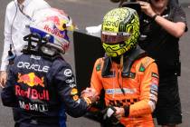 FILE - McLaren driver Lando Norris of Britain, right, shakes hands with Red Bull driver Max Ver ...