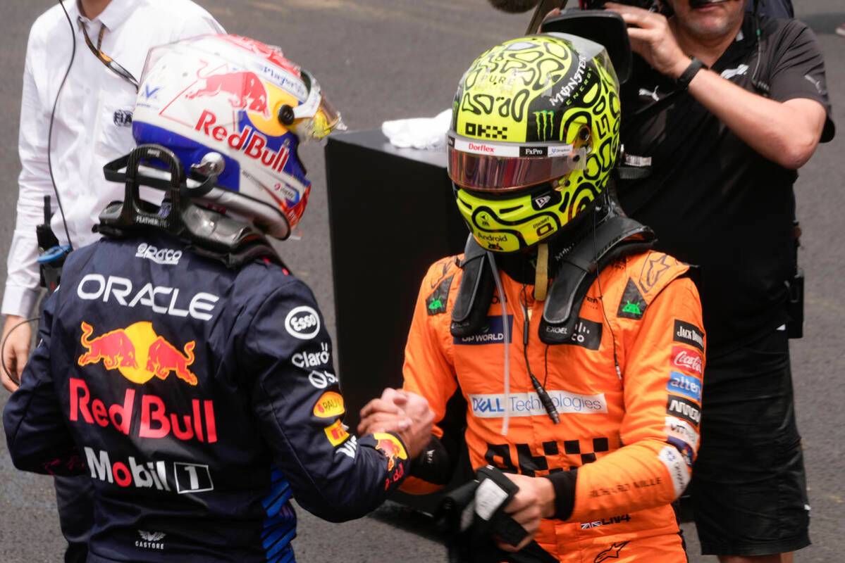 FILE - McLaren driver Lando Norris of Britain, right, shakes hands with Red Bull driver Max Ver ...