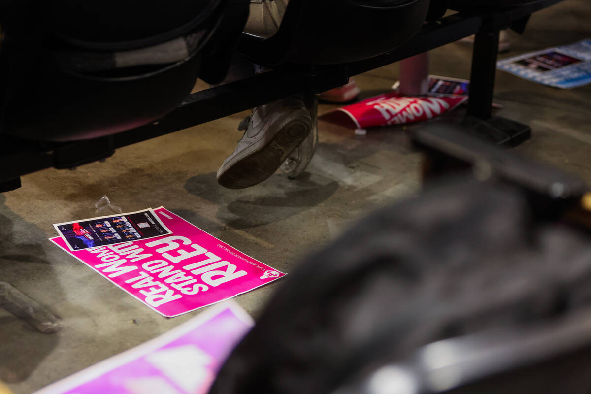 Signs sit at Riley Gaines’ supporters’ feet during an event hosted by UNLV&#x2019 ...