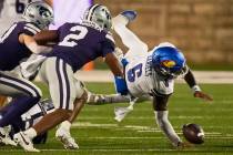 Kansas quarterback Jalon Daniels (6) fumbles the ball after being tackled by Kansas State lineb ...