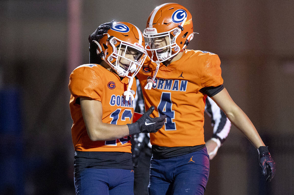 Bishop Gorman wide receiver Aizen Torres (13) and wide receiver Kaina Watson (4) celebrate afte ...