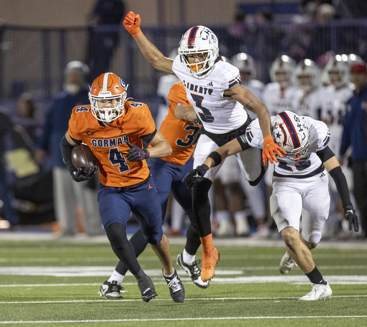 Bishop Gorman wide receiver Kaina Watson (4) avoids Liberty defensemen during the Class 5A Divi ...