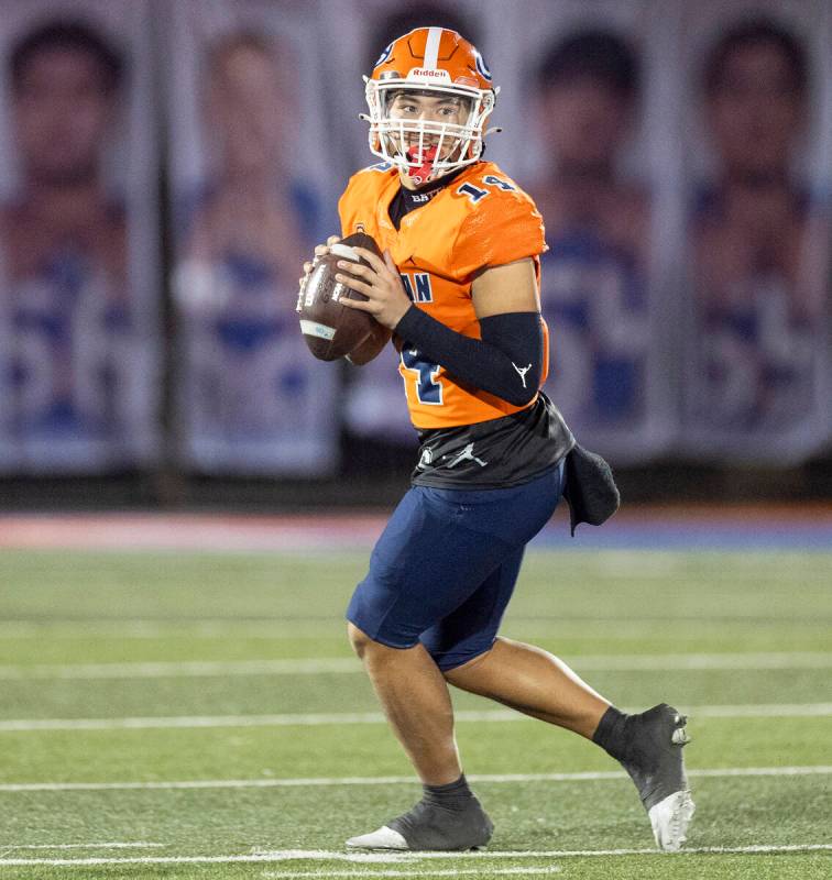 Bishop Gorman quarterback Maika Eugenio (14) looks to throw the ball during the Class 5A Divisi ...