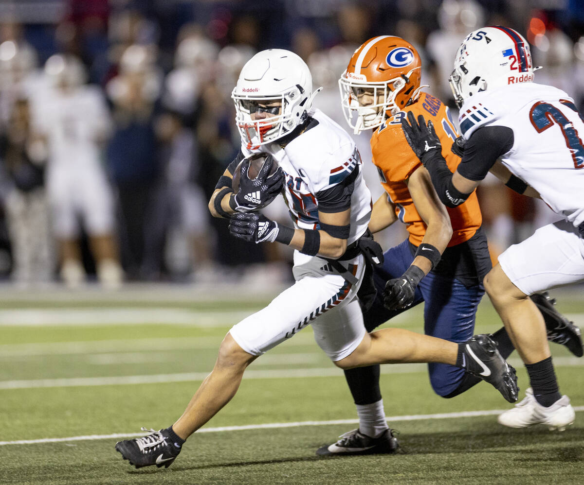 Liberty freshman Champion-James Ualesi, left, runs with the football after intercepting a pass ...