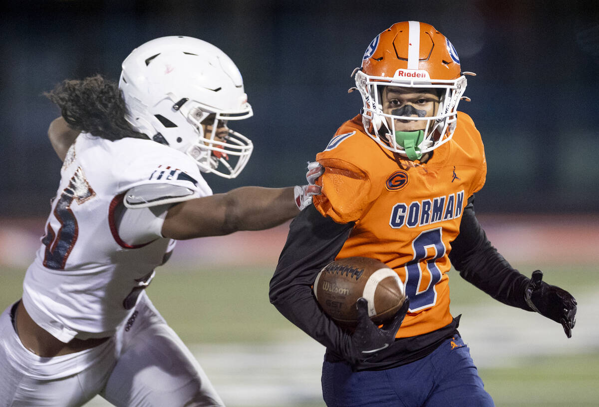 Bishop Gorman defensive back Isaiah Nickels (0) runs with a punted ball, avoiding Liberty offen ...