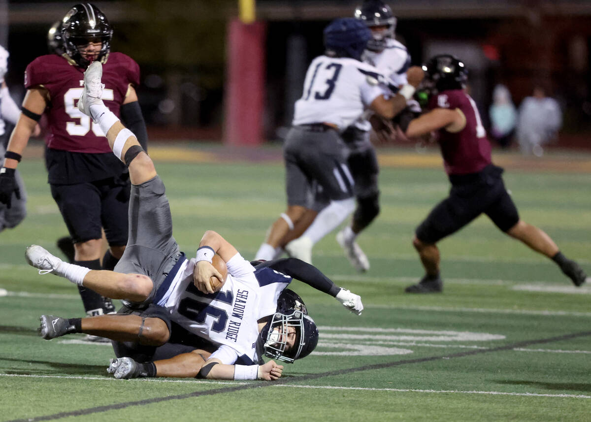 Shadow Ridge quarterback Gage Crnkovic (16) is brought down by Faith Lutheran in the second qua ...