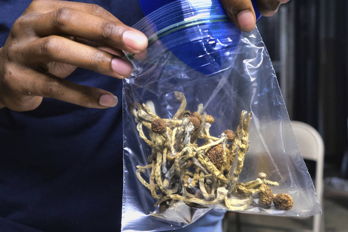 A vendor bags psilocybin mushrooms at a cannabis marketplace on May 24, 2019 in Los Angeles. (A ...