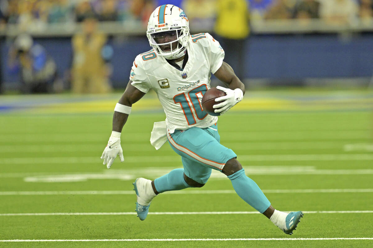 Miami Dolphins wide receiver Tyreek Hill carries the ball during an NFL football game against t ...