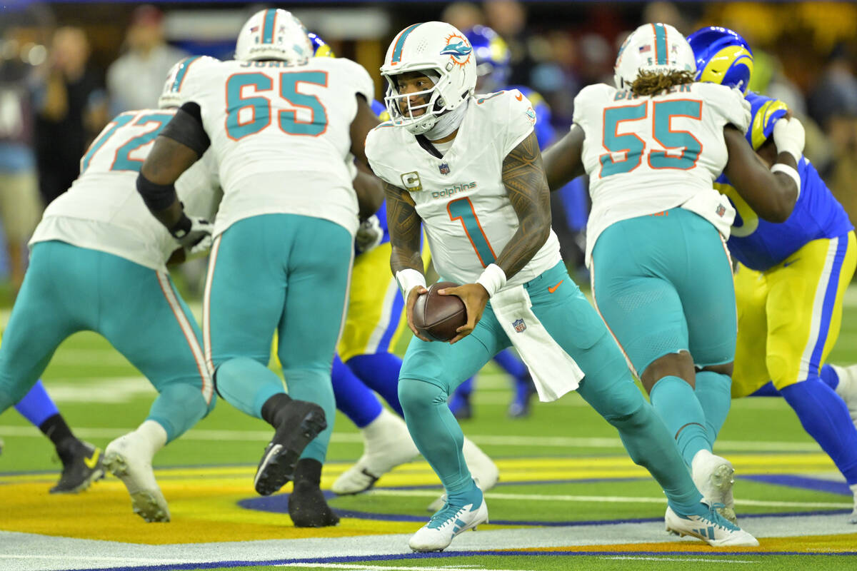 Miami Dolphins quarterback Tua Tagovailoa pitches the ball during an NFL football game against ...