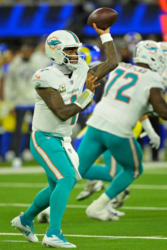 Miami Dolphins quarterback Tua Tagovailoa sets to throw a pass during an NFL football game agai ...