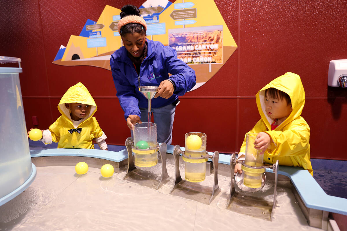 SirNigel Bonds, 2, of Las Vegas, left, and Carter Li, 3, of San Diego watch presenter Mahaleah ...