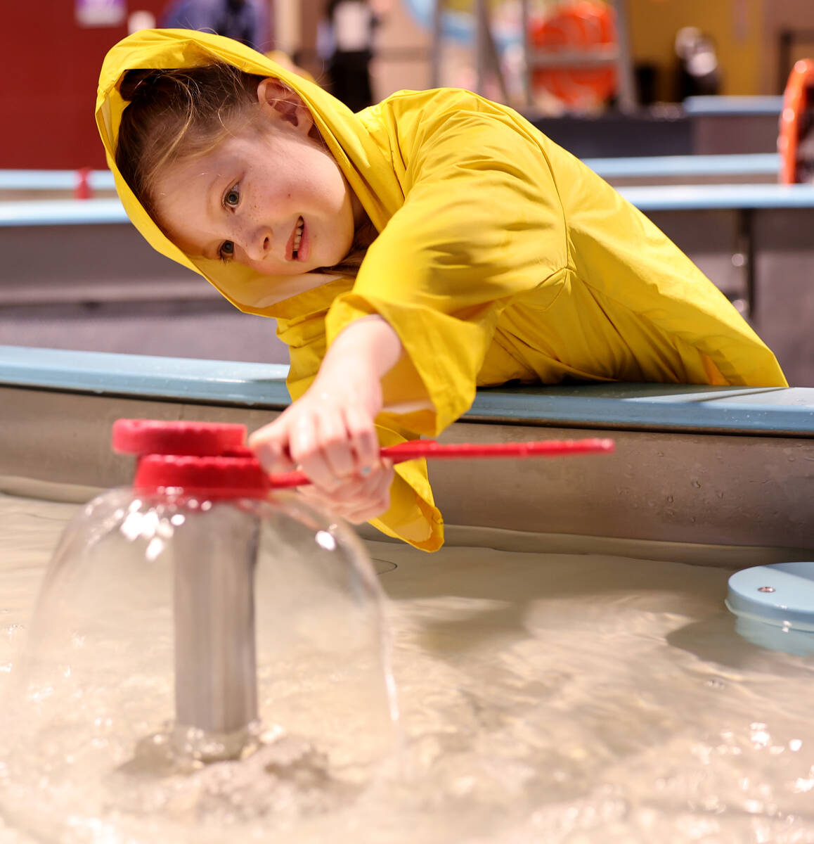 Evelyn Andrikut, 5, of Reno makes shapes with water in the ‘Water World’ exhibit at Discove ...