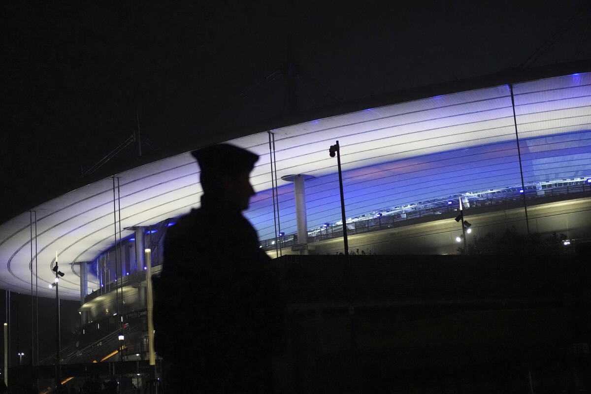 A police officer patrols by the Stade de France during the Nations League soccer match France a ...