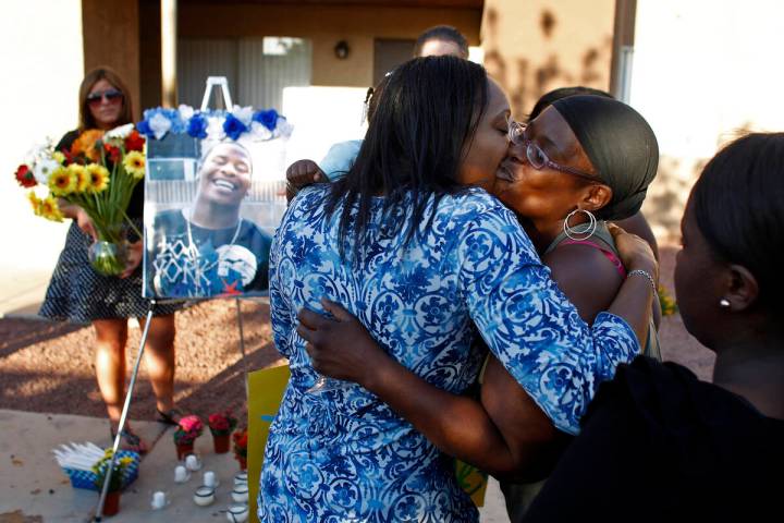 Kimeryn Williams, left, gets a kiss from Trenia Cole during a vigil for Trevon Cole Friday, Jun ...